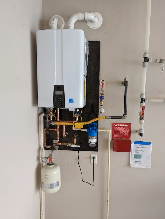 Professional plumber installing copper piping in a Belton home